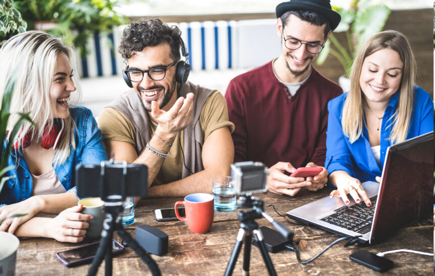 Friends with electronic devices around a table